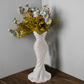 This elegant dress vase combines high-fashion elegance with minimalist home décor. Whether you insert real flowers into the glass tube or display artificial flowers without the tube, it is exceptionally beautiful.