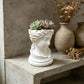 A 3D-printed, broken goddess-themed flowerpot, combining decorative and functional elements, in white.
