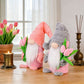 1pc Plush standing gnome doll — faceless old man figurine, festive tabletop ornament and gift.Pink faceless old man gnome holding a bouquet