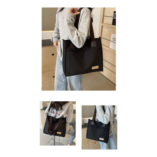 Stylish black canvas tote bag with detachable shoulder strap