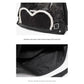 Stylish black tote backpack with heart embellishment - can be worn on one shoulder or as a backpack
