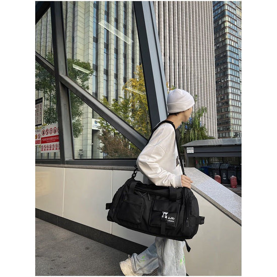 Black Unisex Travel Bag with Utility Buckles and Wet/Dry Compartments