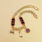 Gold-Tone Chain Bracelet with Red and Black Beads, Elephant Charm, Feather Pendant, and Round Stone Accent – 19 cm Length