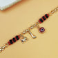 Gold-Tone Chain Bracelet with Red and Black Beads, Elephant Charm, Feather Pendant, and Round Stone Accent – 19 cm Length