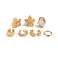 7-Piece Molten Gold Tone Ring Set - Baroque Faux Pearl, Flower, Chain Link & Abstract Shield Bands - Ultimate Adjustable Boho Stackable Jewellery
